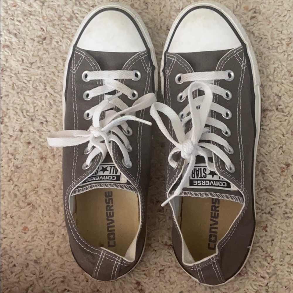 moderately worn low top grey converses